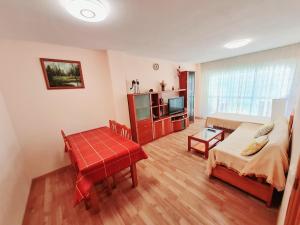 a living room with a bed and a television at Apartamento Aqua in La Pineda