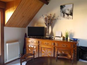 a wooden cabinet with a television on top of it at La Biasou in Gèdre