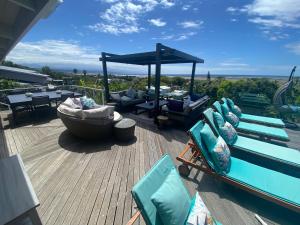 a deck with chairs and a gazebo on a house at Lasalle holiday home (Sun, Beach, Views, Fun for everyone!) in Plettenberg Bay