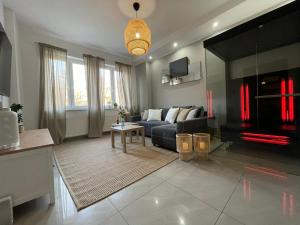 a living room with a couch and a table at APARTMENT SAUNA INFRARED in Szczecin