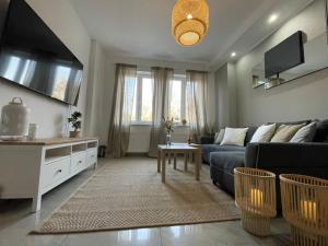 a living room with a couch and a table at APARTMENT SAUNA INFRARED in Szczecin