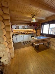 a kitchen with a table in a log cabin at Будиночок-зруб в центрі Пилипця in Pilipets +25 photos