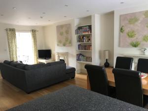 a living room with a couch and a table at Swallows Nest in Bradwell