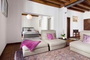 a living room with a couch and a bed at San Clemente in Crema