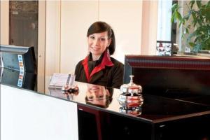 a woman standing behind a counter in a store at Eden Hotel in San Salvo