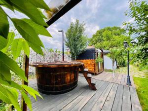 a large wooden barrel sitting on a wooden deck at Agropa Garden in Bistriţa