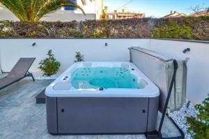 a bath tub sitting on top of a patio at Villa Villetta in Novigrad Istria