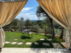 a patio with a table in the grass at Oliveta del Verde Appartamento con Grande Giardino 500mt dal Centro in Siena +10 photos