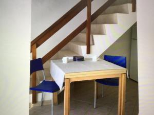 a table with two chairs and a staircase at Leme Bedje GST84 3 bedroom apt with Panaramic views in Santa Maria