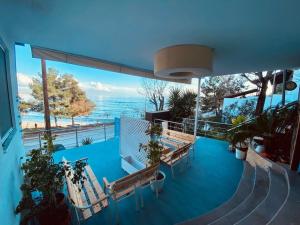 a balcony with benches and a view of the ocean at ElGreco By the sea in Nea Karvali