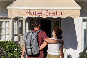 a man and woman standing outside of a hotel erato at Erato Hotel in Agia Marina Aegina