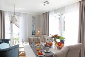 a living room with a table with fruit on it at Suite Salzluft mit Sauna in Zingst