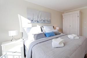 a bedroom with a large bed with two pillows on it at Suite Salzluft mit Sauna in Zingst