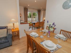 a dining room and living room with a table and chairs at Pierpont D1 in Yarmouth