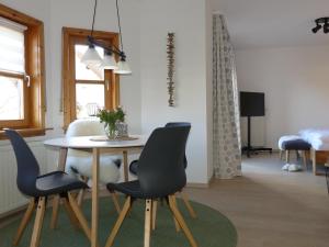 a dining room with a table and chairs at Appartement Buchstein 