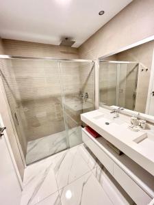a bathroom with a shower and a sink at Sunset Drive Resort & Spa in Benidorm