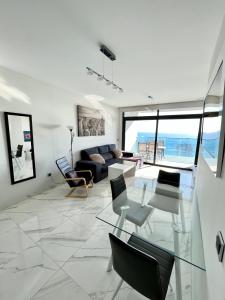 a living room with a couch and a table and chairs at Sunset Drive Resort & Spa in Benidorm