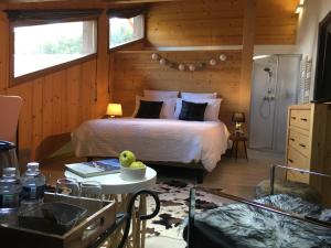 a bedroom with a bed and a table with a bowl of fruit on it at Montagn'Arcs in Bourg-Saint-Maurice