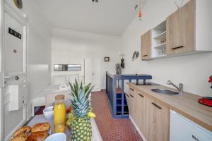 a kitchen with a table with a pineapple on it at Loft in heart of Paris Moulin Rouge in Paris