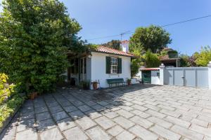 a house with a paver driveway in front of it at Tapadinho Nature and Pool - Countryside Villa in Raiva