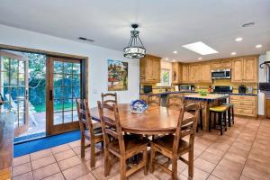 a large kitchen with a wooden table and chairs at Great Group Retreat! Hacienda Decor, Spacious Floor Plan, Private Backyard in Carlsbad