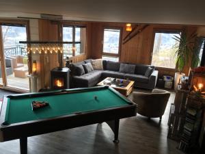 a living room with a pool table in it at Montagn'Arcs in Bourg-Saint-Maurice