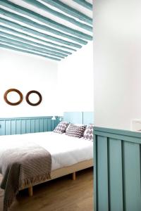 a bedroom with a bed with blue and white walls at Apartamentos Principe 7 in Madrid