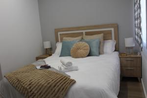 sypialnia z dużym białym łóżkiem z niebieskimi poduszkami w obiekcie Apartamento Catedral w mieście Almería