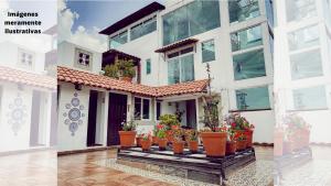 a collage of photos of a house with potted plants at Suites Aldama in Toluca