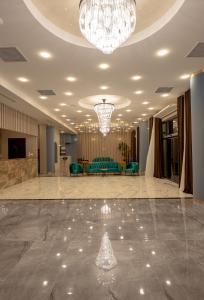 Großes Zimmer mit einem Kronleuchter und einer Lobby in der Unterkunft Hotel Residence Plaza in Tbilisi City