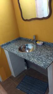 a bathroom counter with a sink and a mirror at Casa con Gran Patio in Villa Parque Siquiman