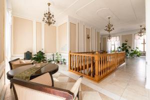 a living room with a table and chairs at Palace Hotel in Nyasvizh