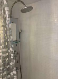 a bathroom with a shower with a shower curtain at El capricho de Nina en Lavapiés in Madrid