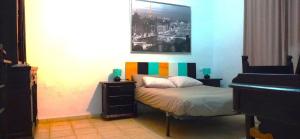 a small bedroom with a bed and a piano at Spa, Sierra y sol in Cortes de la Frontera +67 photos