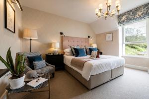 a bedroom with a large bed and a large window at Carbis Bay and Spa Hotel in St Ives
