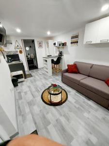 a living room with a couch and a table at Quiet and cosy studio near Cattenom, Luxembourg and Metz in Haute-Yutz