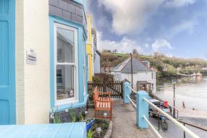 a window of a house with a view of a river at The Slipway Fowey Harbour Parking 1 Min & Garden in Fowey
