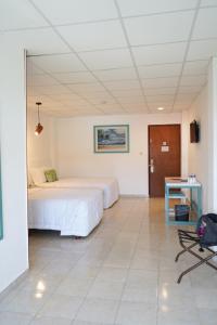 Postel nebo postele na pokoji v ubytování Hotel & Suites Arges - Centro Chetumal