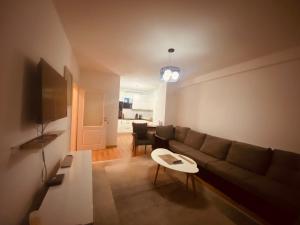a living room with a couch and a table at 1 Bedroom flat in Kosovo Polje