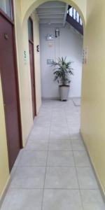an empty hallway with a potted plant in a building at Anciejo inn ll in Lima