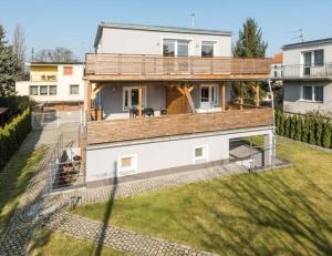 an image of a house with a large deck at Villa Arkodes in Gdańsk