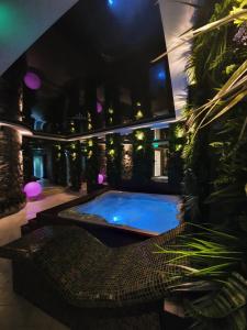 a swimming pool in the middle of a house at night at Dream House Hotel & Spa in Kolašin