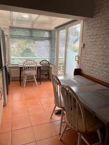 a dining room with a table and chairs at Aeronfa in Llanfairfechan