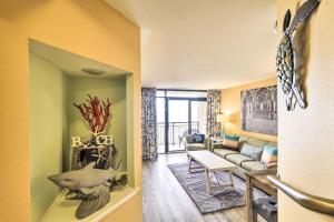 a living room with a couch and a table at Beachfront Resort Condo with Lazy River and Pools! in Myrtle Beach