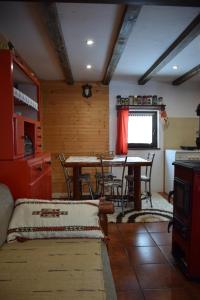 a kitchen with a table and chairs in a room at Zeleni Breg in Zlatibor