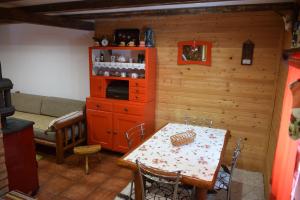 a living room with a table and a couch and a kitchen at Zeleni Breg in Zlatibor +57 photos