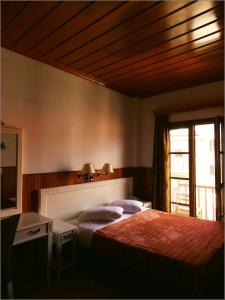 Postel nebo postele na pokoji v ubytování Hotel Olympic