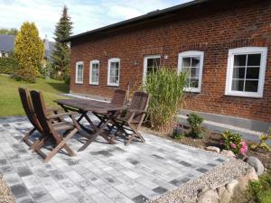 a wooden table and chairs on a patio at Ferienhaus Jantzen in Süsel