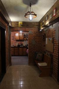 a living room with a brick wall and a couch at PUSTELNIA WODZA in Wisła