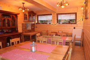 a dining room with wooden tables and chairs at PUSTELNIA WODZA in Wisła